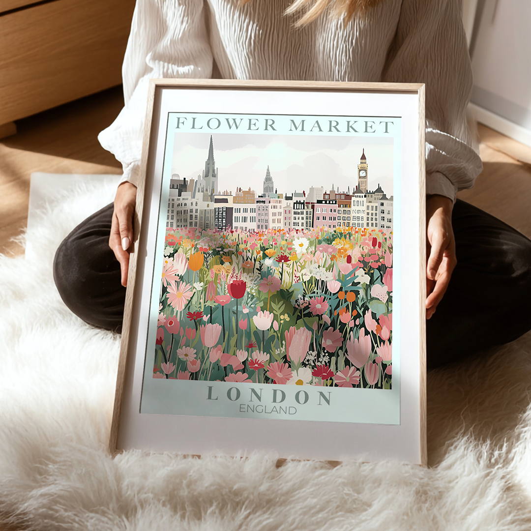 Person holding a framed print of 'Flower Market, London, England' with floral design and cityscape.