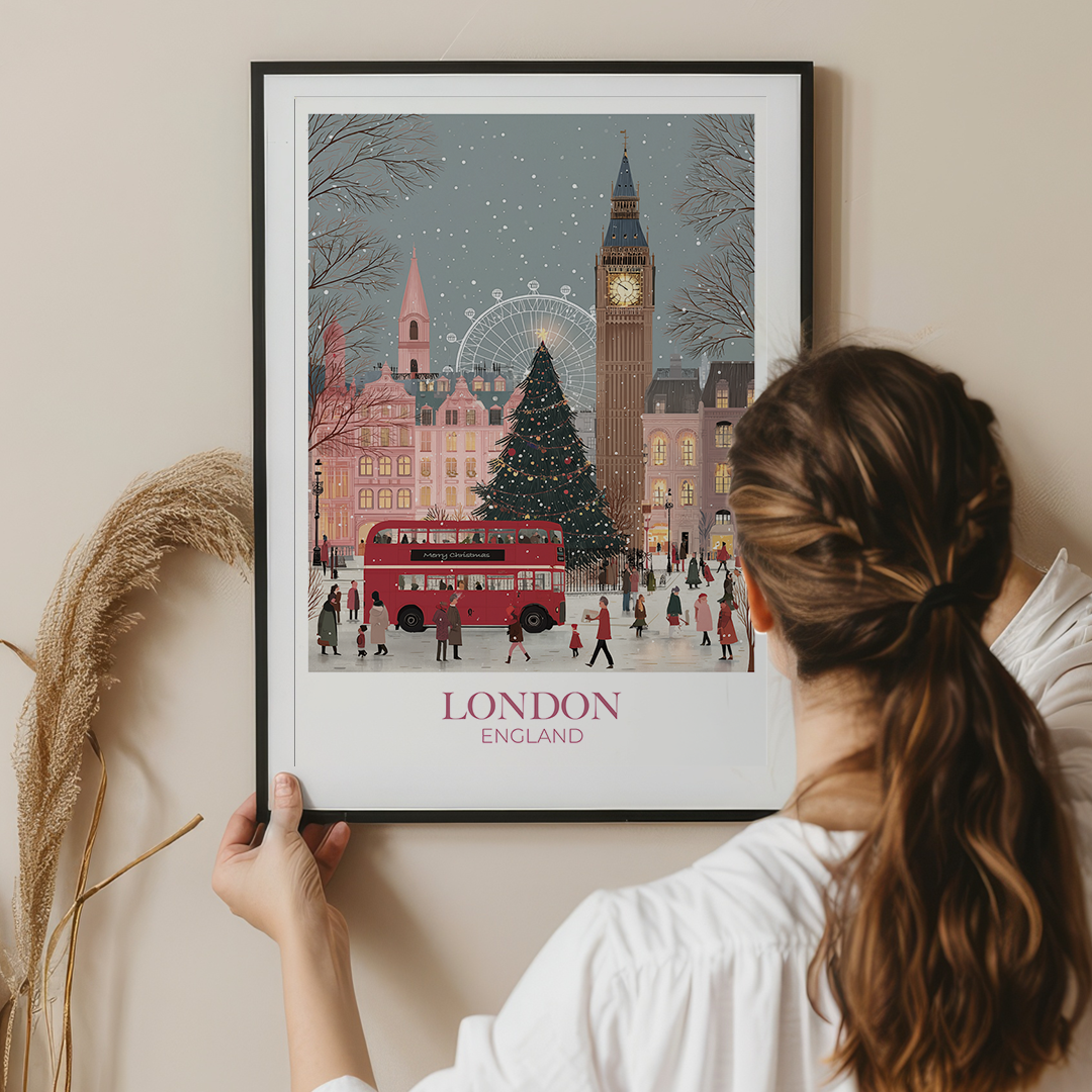 Woman holding a framed print of London with Big Ben and a Christmas tree.
