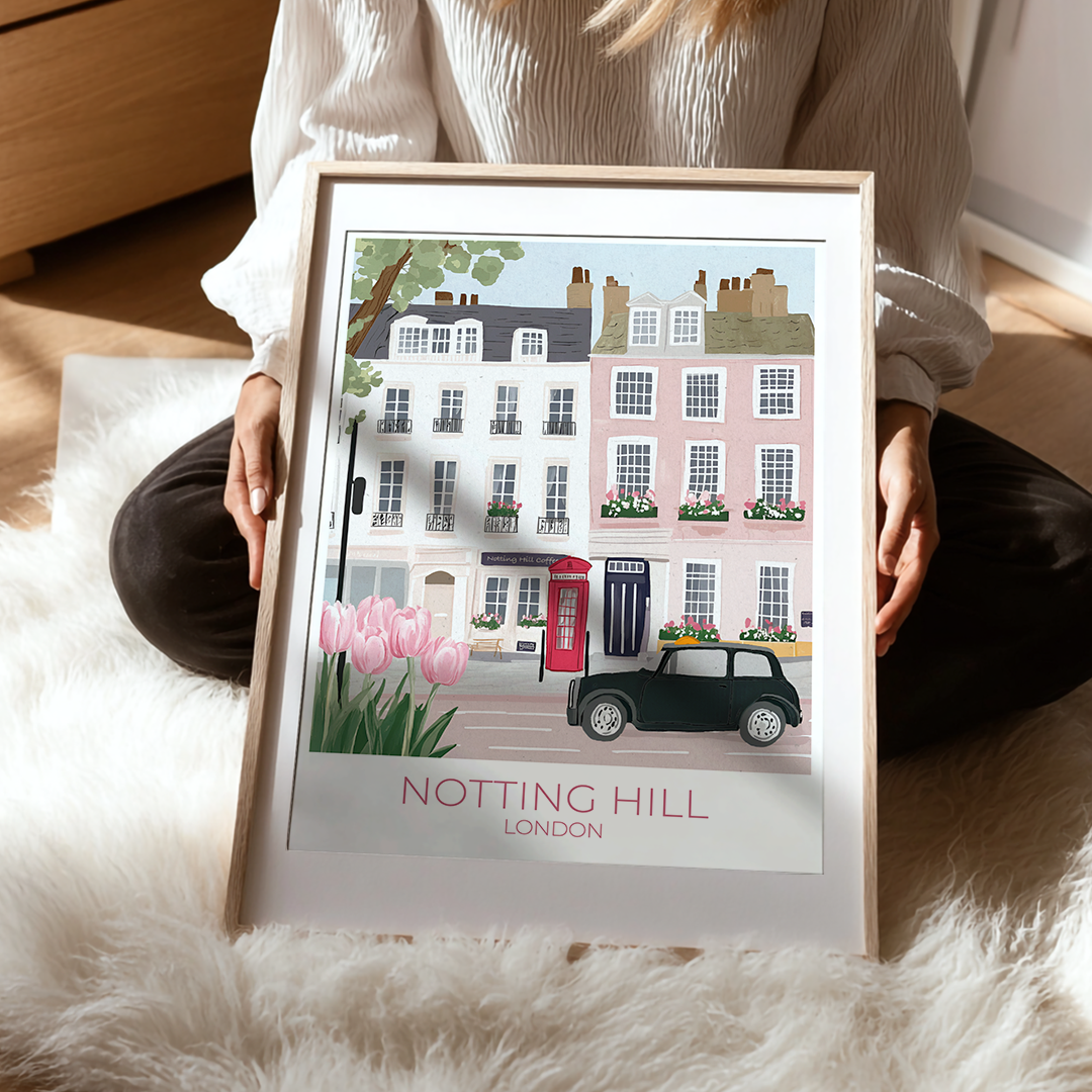 Framed artwork of Notting Hill, London with a person holding it.