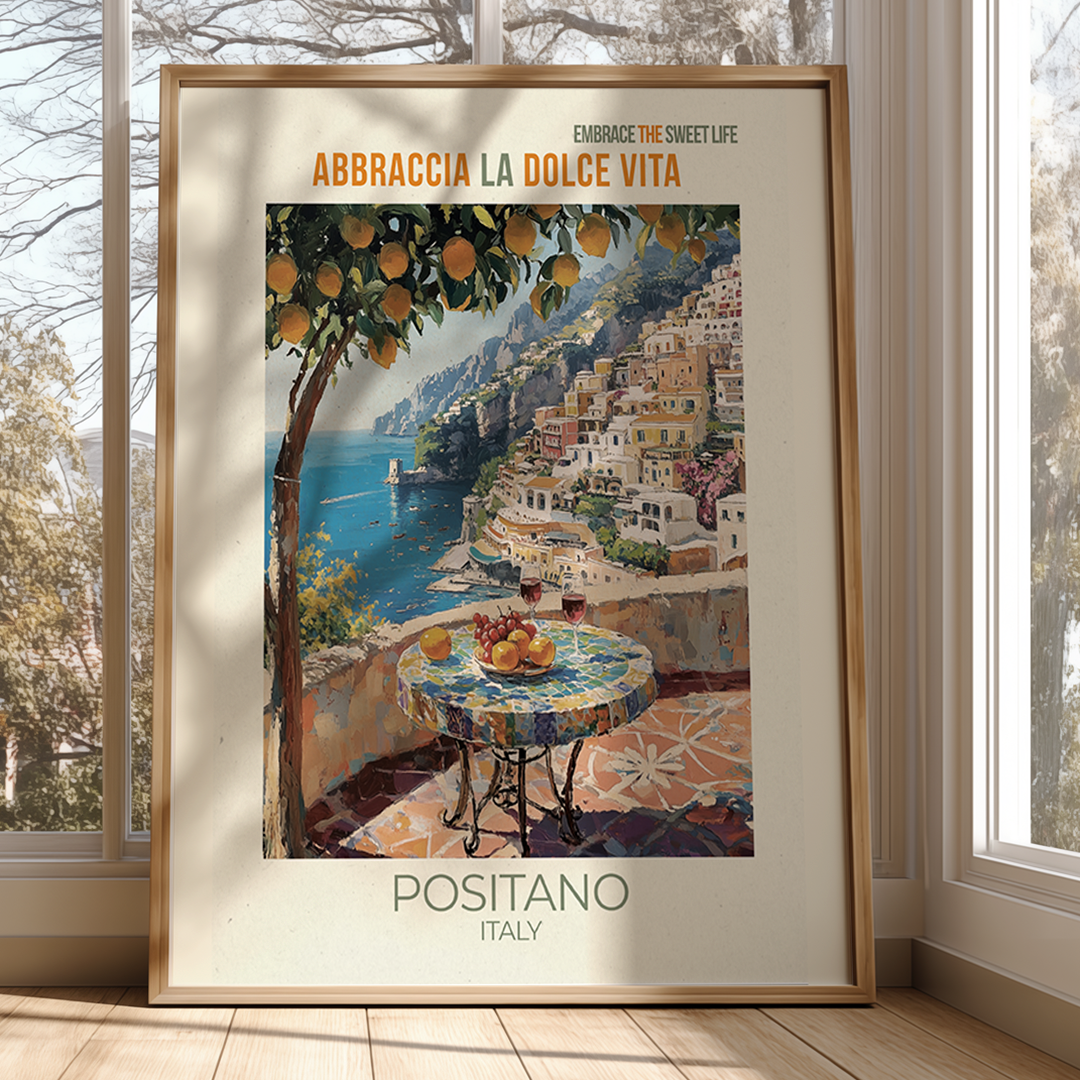 Framed artwork of Positano, Italy with a scenic view and table setting.