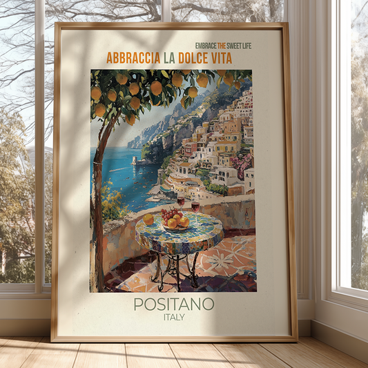 Framed artwork of Positano, Italy with a scenic view and table setting.