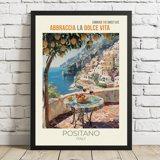 Framed artwork of Positano, Italy with a scenic view and text on a white brick wall.