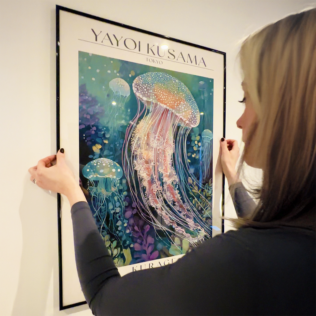 Framed Kurage jellyfish art print by Yayoi Kusama, modern Japanese wall art with vibrant ocean colors, hanging on a white wall.