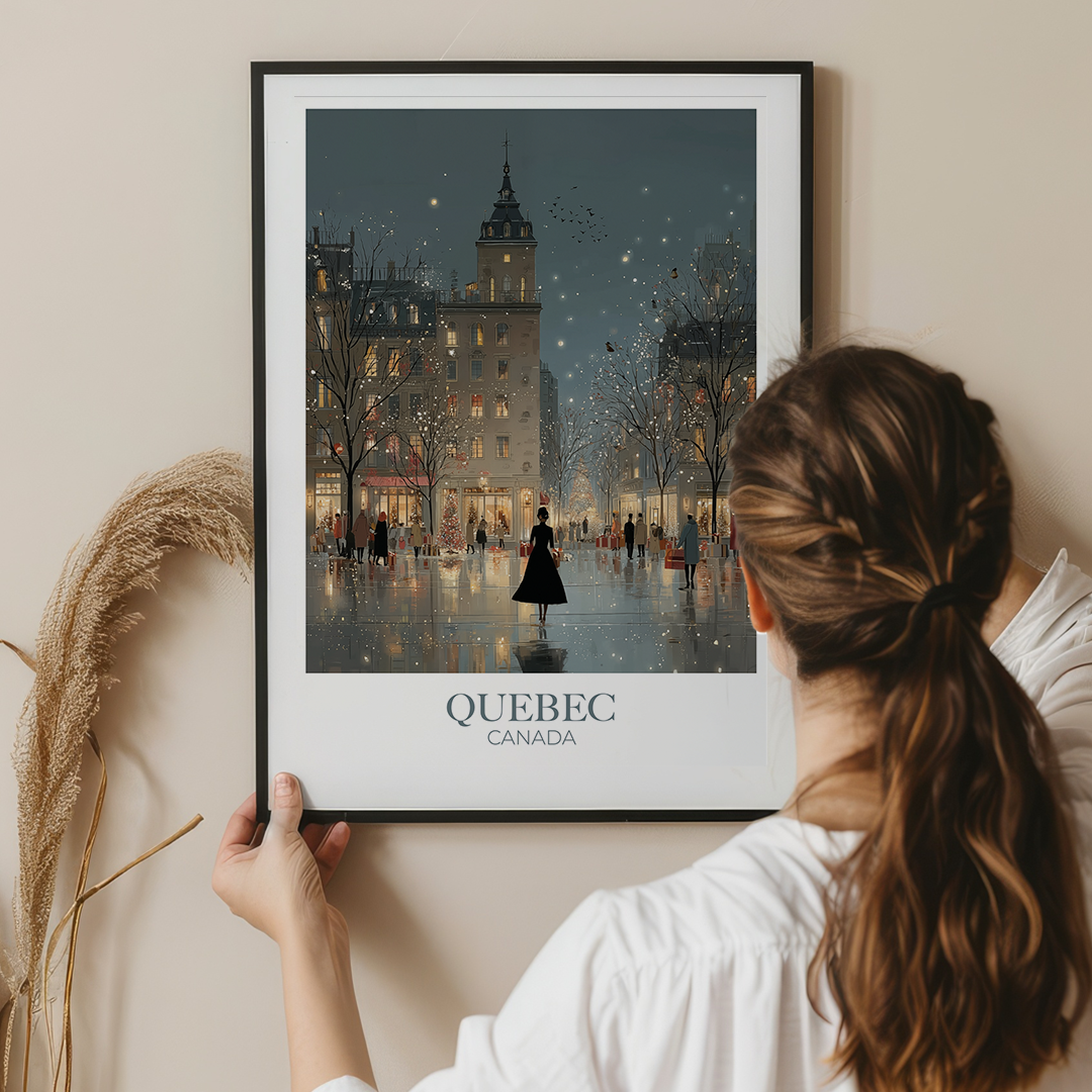 Person holding a framed print of Quebec City at night