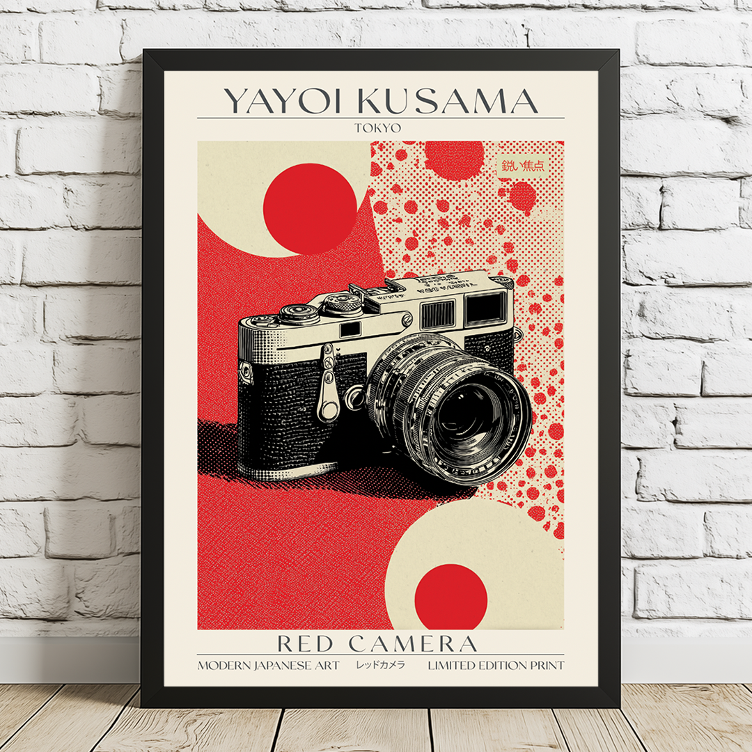 Framed poster of a camera with red and beige design on a white brick wall.