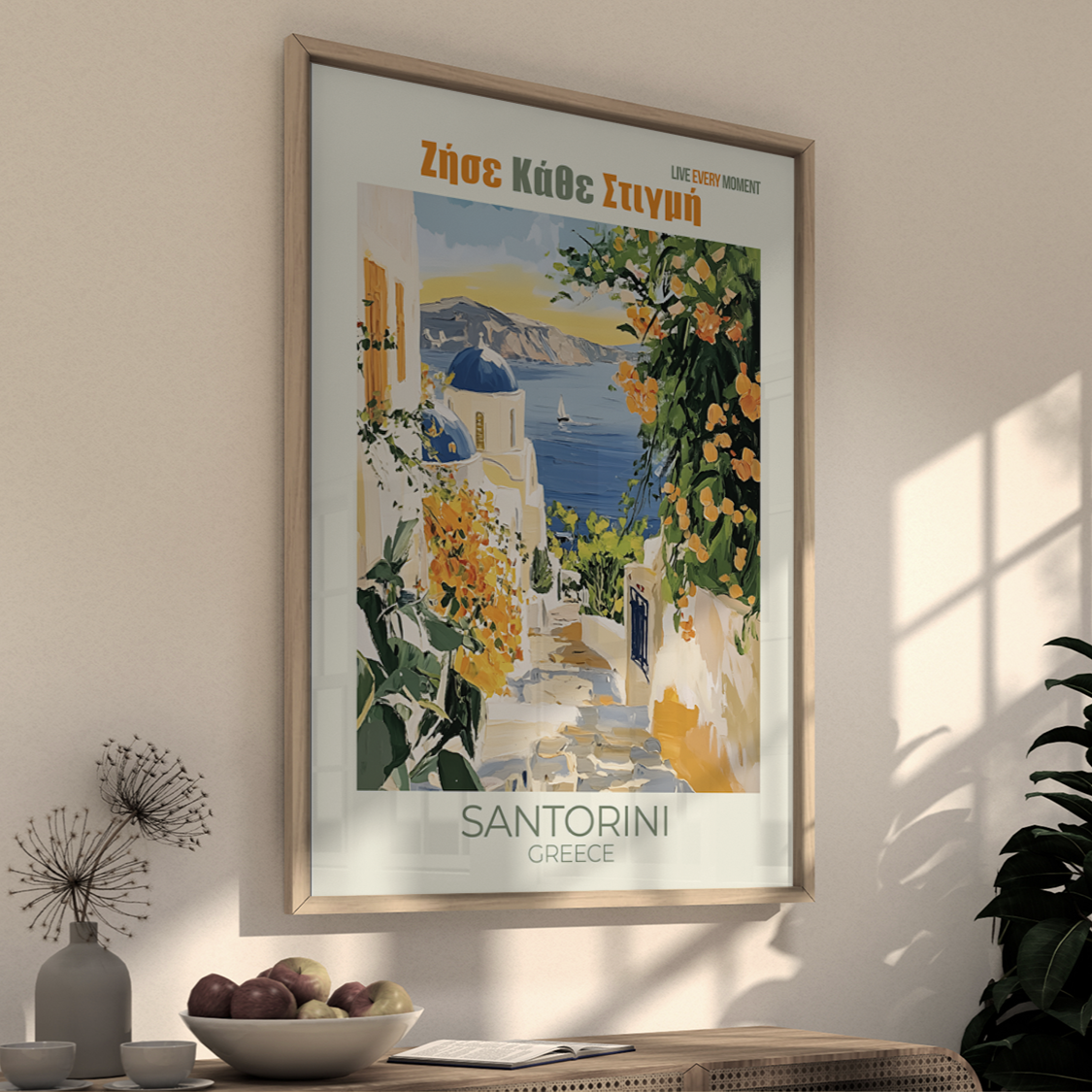 Framed Santorini travel poster on a wall with decorative elements.