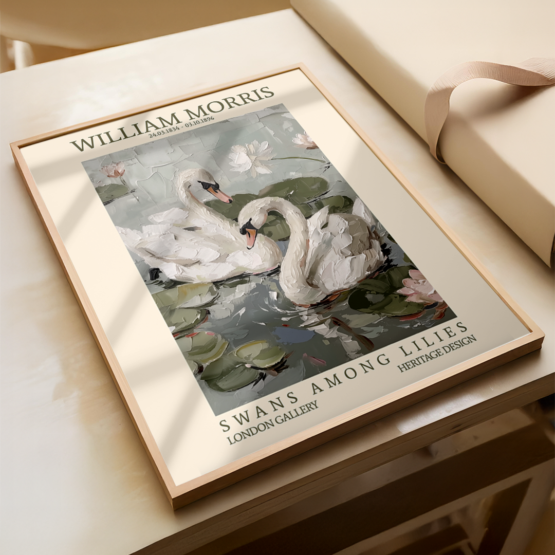 Framed artwork of swans among lilies by William Morris on a wooden surface.