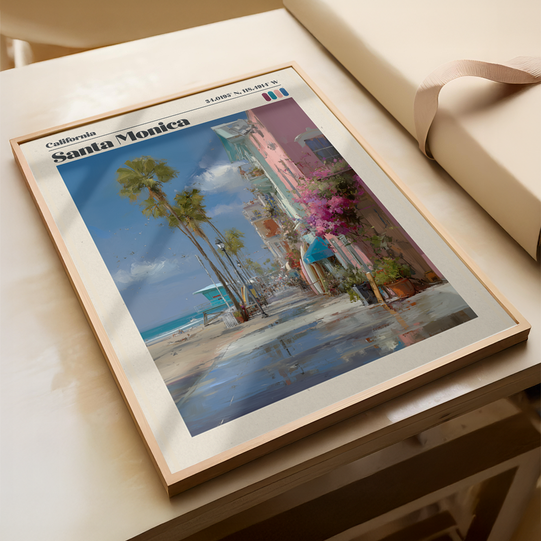 Framed artwork of Santa Monica beach scene on a wooden surface