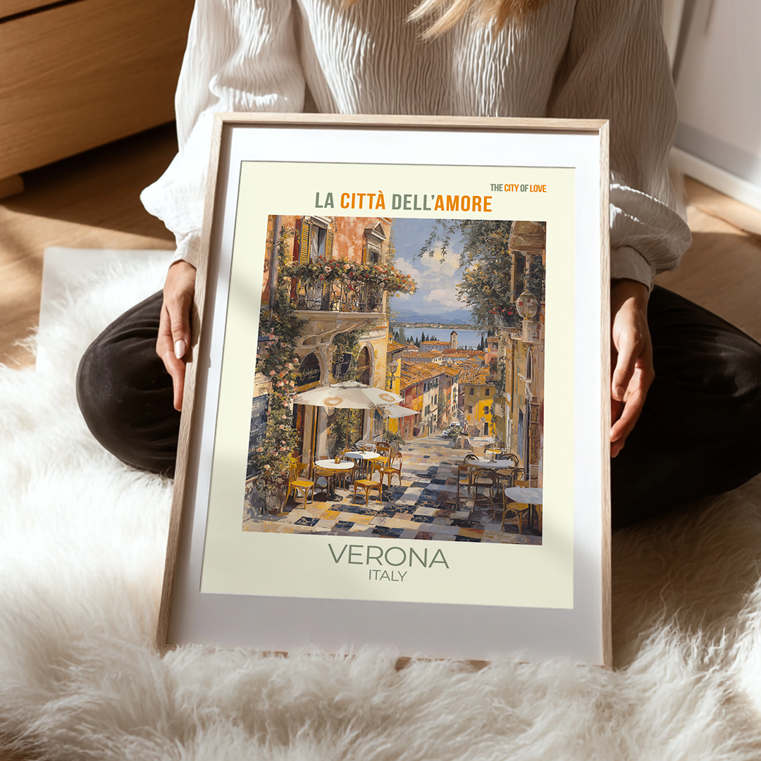 Person holding a framed print of Verona, Italy with a scenic view.